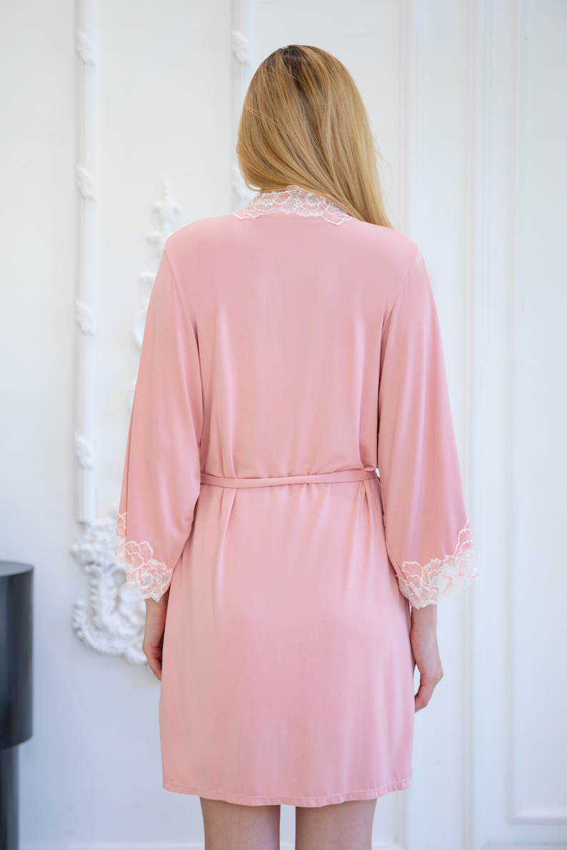 Back view of elegant pink robe with lace trim from a top sleepwear factory, crafted by expert pajamas manufacturers.
