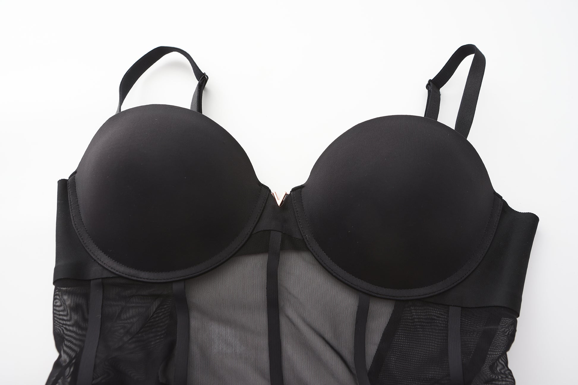 Detailed close-up of a black bodysuit with smooth cups and mesh paneling from a leading nightgown factory, designed by a top sleepwear factory or pajamas manufacturers for premium and alluring nightwear.